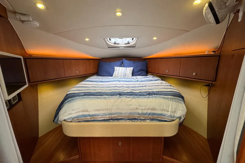 Slide: The Image of Luxurious cabin interior of 2008 Tiara Yachts 3900 Sovran with cozy bed and ambient lighting. - 51
