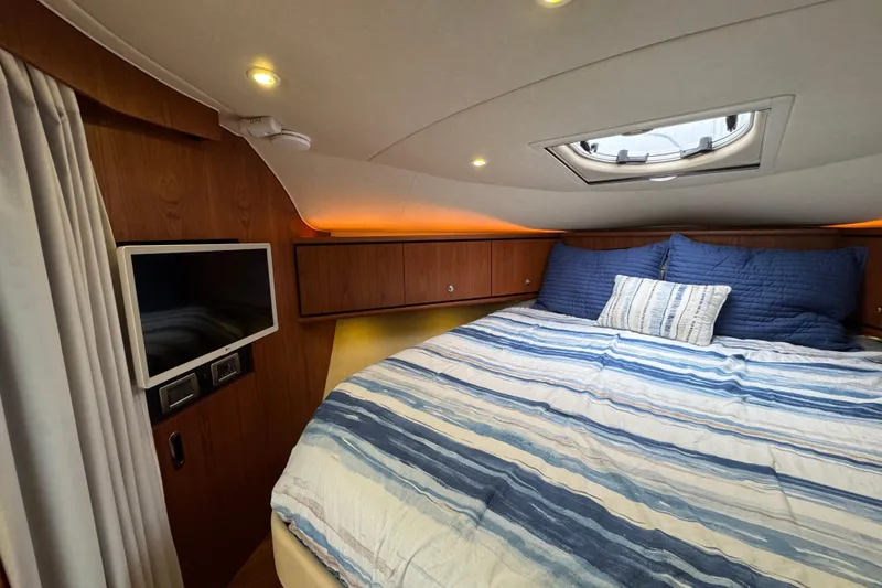 Slide: The Image of 2008 Tiara Yachts 3900 Sovran cabin with bed, TV, and porthole. - 52