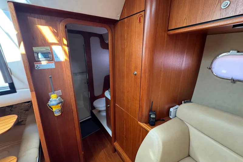 Slide: The Image of Interior of 2008 Tiara Yachts 3900 Sovran, featuring wood cabinetry and a compact bathroom. - 55