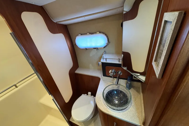 Slide: The Image of Luxurious 2008 Tiara Yachts 3900 Sovran bathroom with modern fixtures and porthole window. - 58