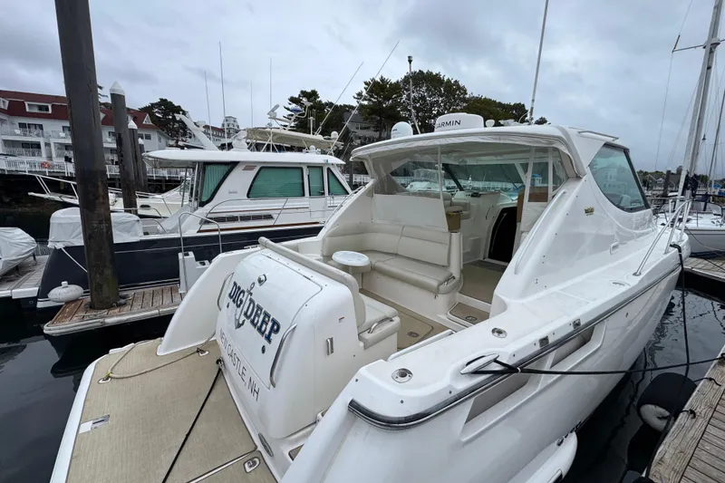 Slide: The Image of 2008 Tiara Yachts 3900 Sovran docked at marina, showcasing sleek design and spacious seating. - 6