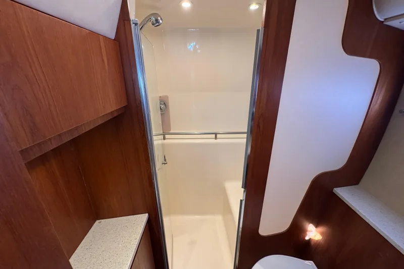 Slide: The Image of 2008 Tiara Yachts 3900 Sovran bathroom with wood accents and modern shower. - 60