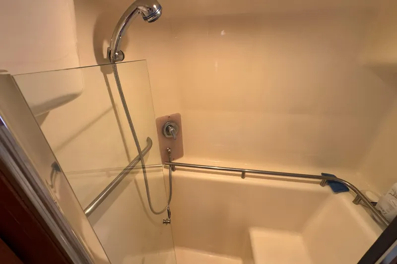 Slide: The Image of Shower area in 2008 Tiara Yachts 3900 Sovran, featuring handheld showerhead and safety rail. - 61