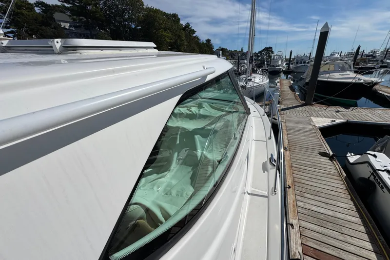 Slide: The Image of 2008 Tiara Yachts 3900 Sovran docked at marina, showcasing sleek design and windows. - 72