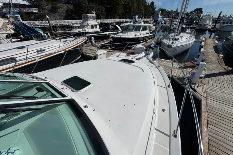Slide: The Image of 2008 Tiara Yachts 3900 Sovran docked among other boats at a marina. - 73