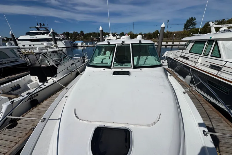 Slide: The Image of 2008 Tiara Yachts 3900 Sovran docked at marina, surrounded by other boats. - 75