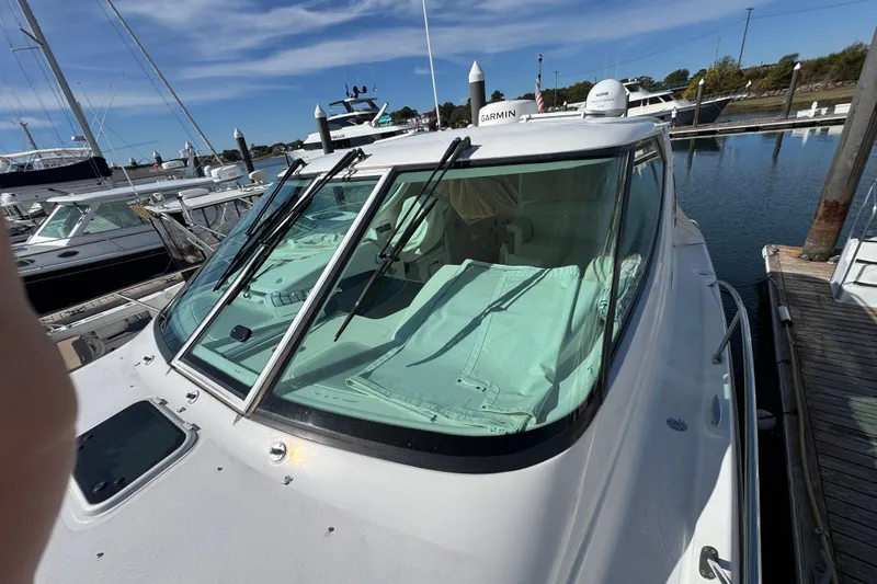 Slide: The Image of 2008 Tiara Yachts 3900 Sovran docked at marina, featuring sleek windshield design. - 76