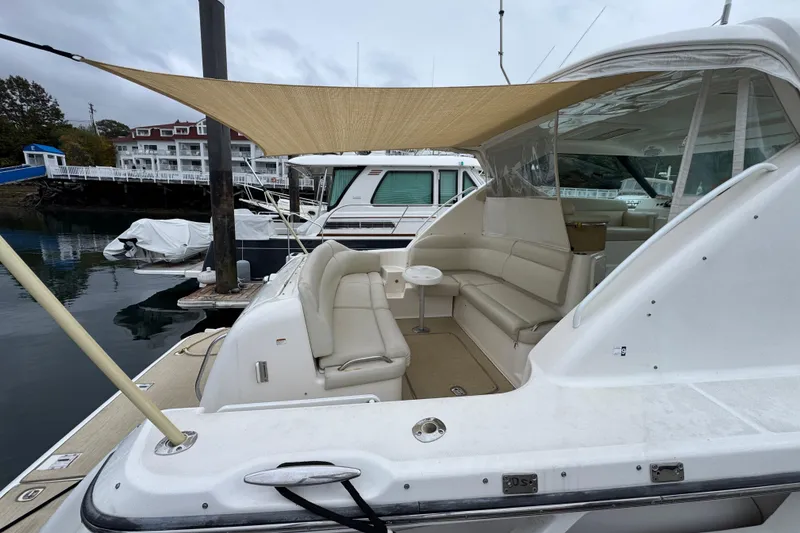 Slide: The Image of 2008 Tiara Yachts 3900 Sovran docked, featuring spacious seating and canopy. - 8