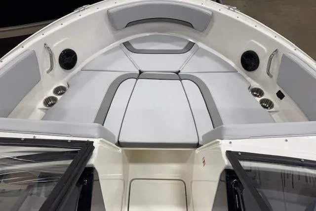 Slide: The Image of 2026 Bayliner V20 boat interior with cushioned seating and cup holders. - 3