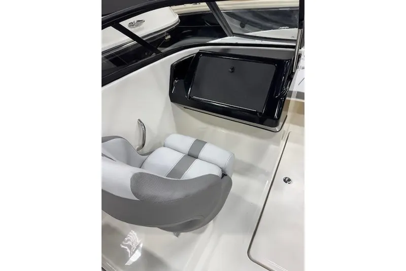 Slide: The Image of 2026 Bayliner V20 boat interior with gray and white seating and dashboard. - 4