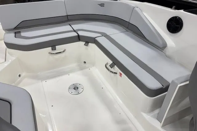 Slide: The Image of 2026 Bayliner V20 boat interior with gray cushioned seating and sleek design. - 7