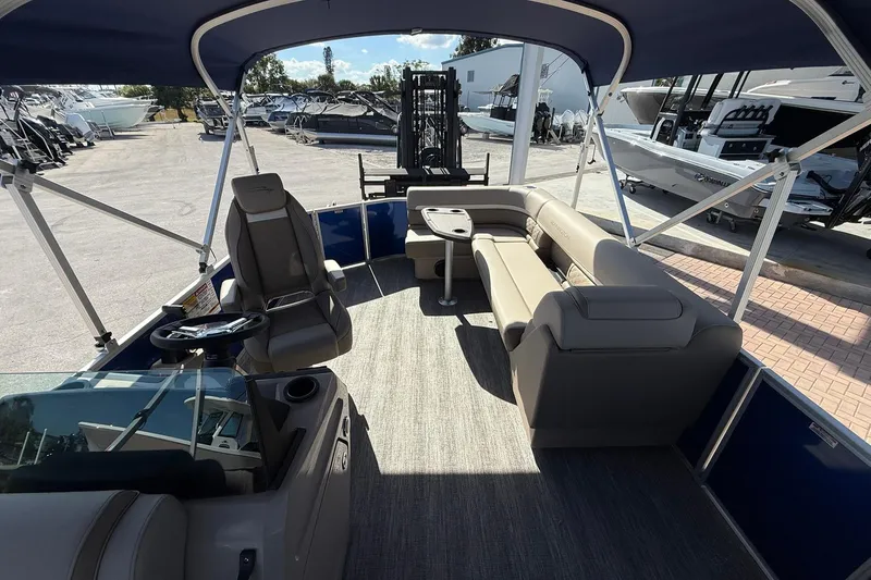 Slide: The Image of 2026 Bennington S 21 SL pontoon boat interior with seating and steering console. - 11