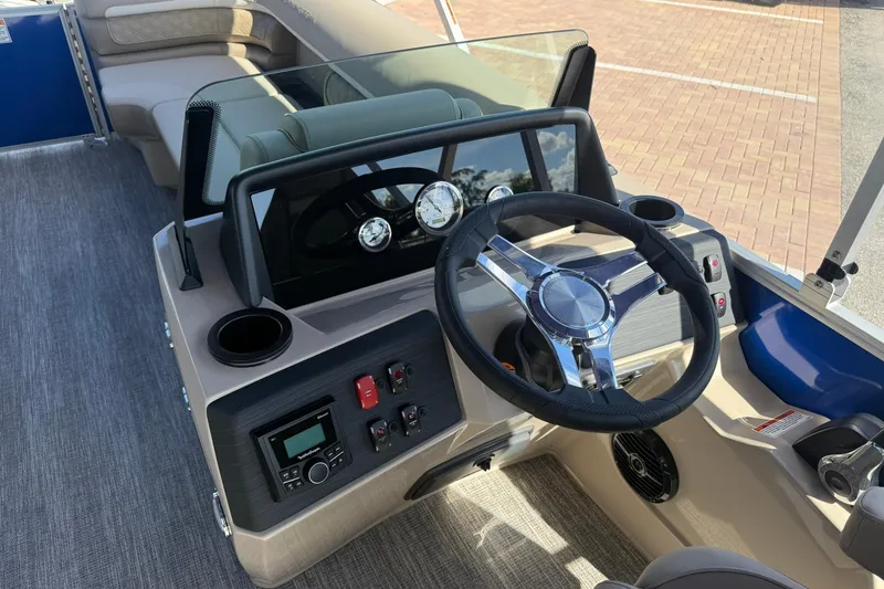 Slide: The Image of 2026 Bennington S 21 SL boat dashboard with steering wheel and controls. - 13