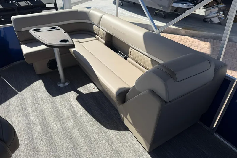 Slide: The Image of Luxurious seating area on 2026 Bennington S 21 SL pontoon boat with table and cup holders. - 15