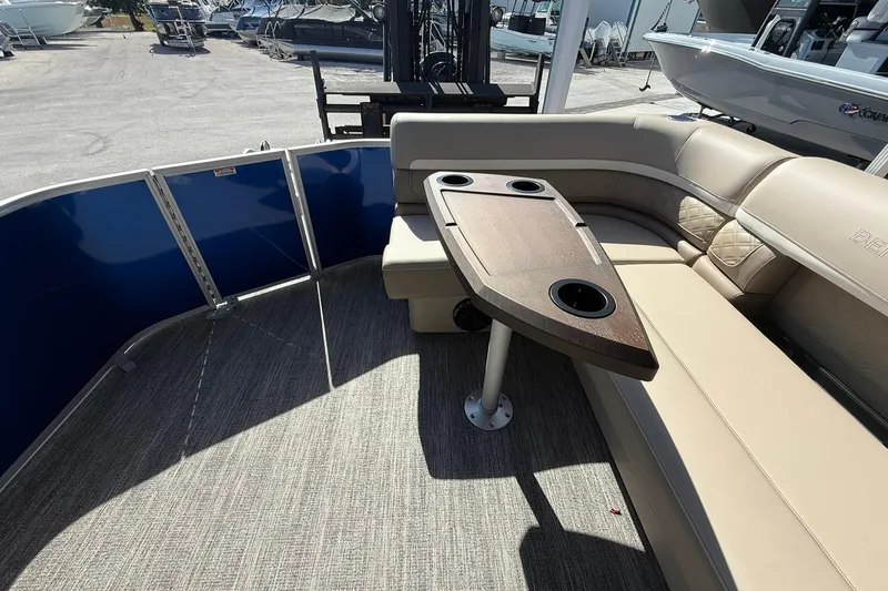 Slide: The Image of Interior of 2026 Bennington S 21 SL pontoon boat with beige seating and wooden table. - 16