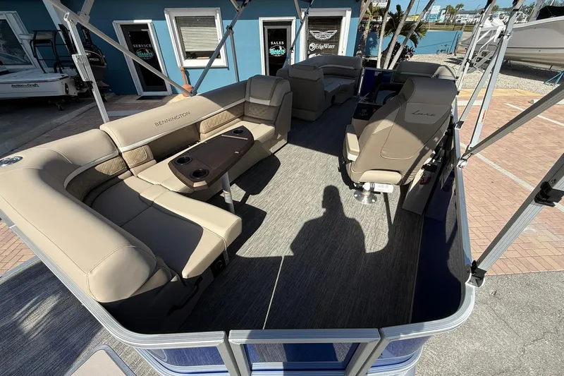 Slide: The Image of 2026 Bennington S 21 SL pontoon boat interior with beige seating and modern design. - 17