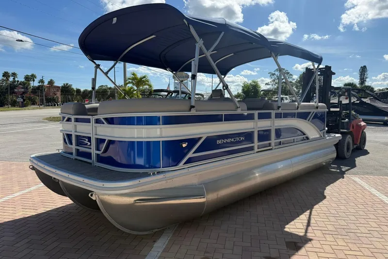 Slide: The Image of 2026 Bennington S 21 SL pontoon boat with blue canopy on a sunny day. - 4