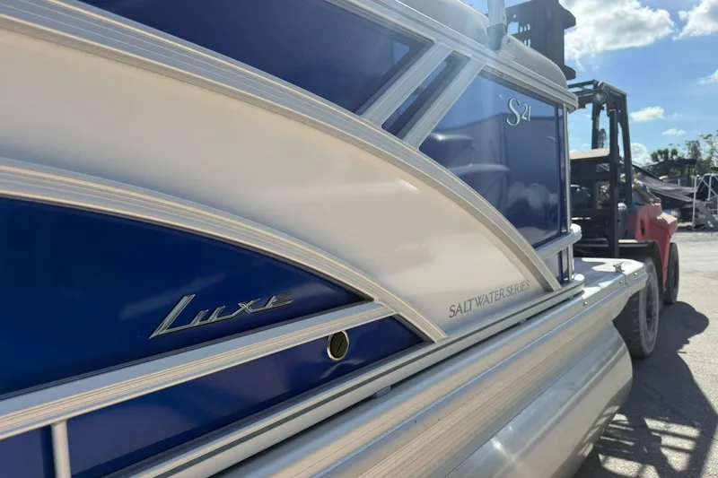 Slide: The Image of 2026 Bennington S 21 SL Luxe Saltwater Series pontoon boat in blue and white. - 5