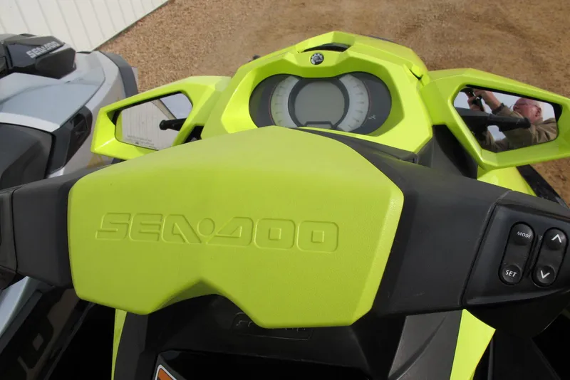 Slide: The Image of 2019 Sea-Doo GTI SE 155 dashboard with vibrant green accents and control buttons. - 4