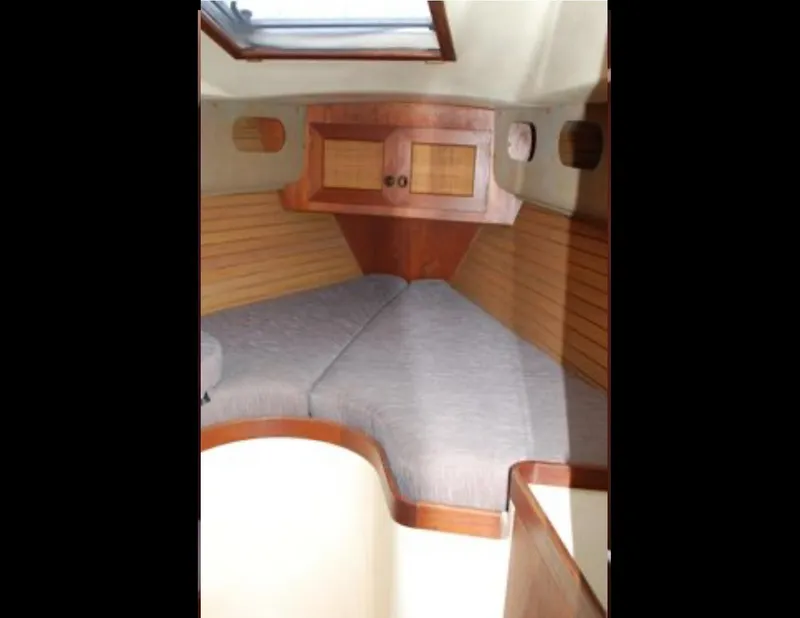 Slide: The Image of 1989 Canadian Sailcraft CS40 yacht interior with wooden cabinetry and cozy sleeping area. - 13