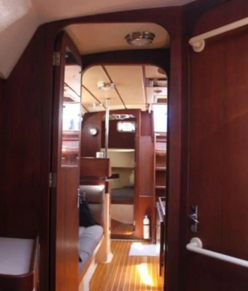 Slide: The Image of 1989 Canadian Sailcraft CS40 yacht interior with wooden finish and cozy seating area. - 16