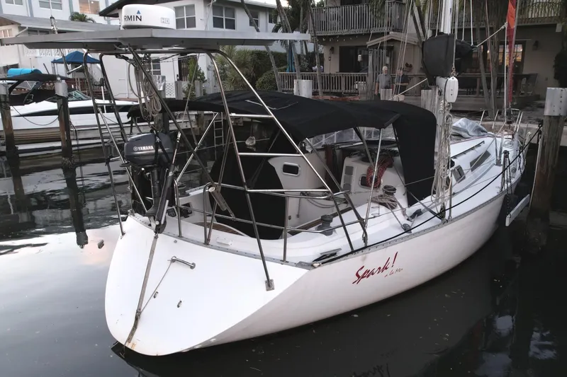 Slide: The Image of 1989 Canadian Sailcraft CS40 sailboat docked, featuring a sleek design and covered cockpit. - 2