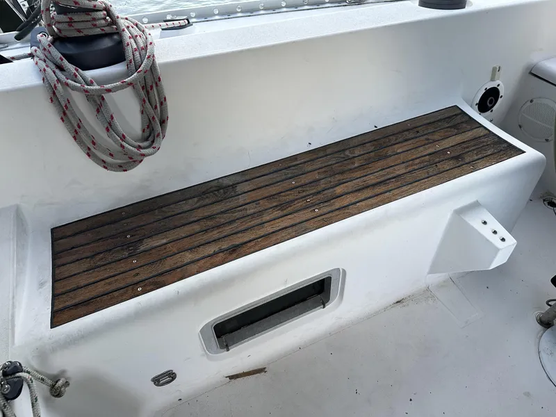Slide: The Image of 1989 Canadian Sailcraft CS40 cockpit with wooden bench and nautical ropes. - 41