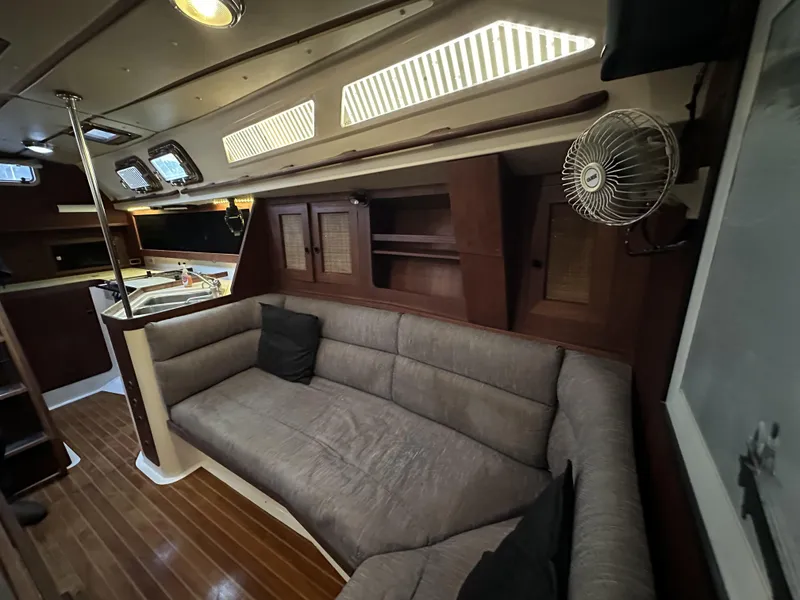 Slide: The Image of 1989 Canadian Sailcraft CS40 yacht interior with cozy seating and wooden accents. - 5
