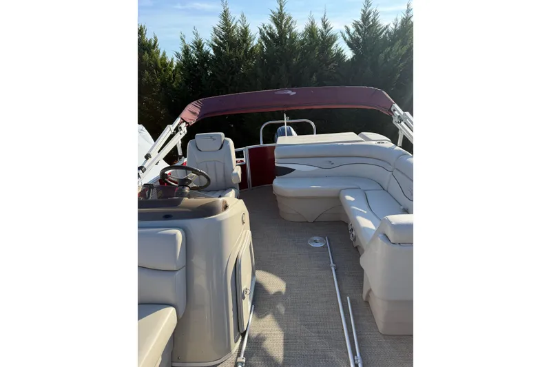 Slide: The Image of 2019 Bennington SX 20 SLX pontoon boat interior with seating and steering wheel. - 3