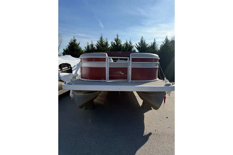 Slide: The Image of 2019 Bennington SX 20 SLX pontoon boat, red exterior, parked on pavement. - 5