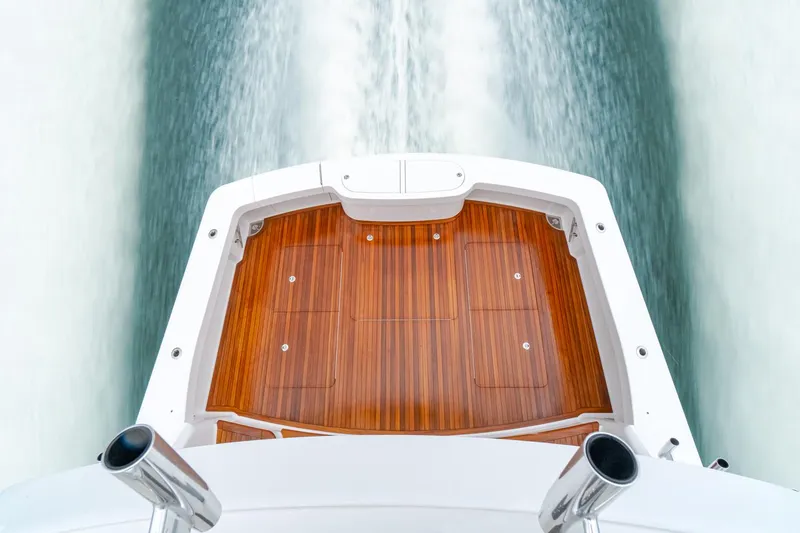 Slide: The Image of 2026 Viking 54 Convertible yacht, wooden deck, cruising at high speed, aerial view. - 1