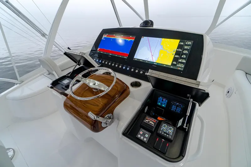 Slide: The Image of Helm of 2026 Viking 54 Convertible yacht with advanced navigation displays and controls. - 16