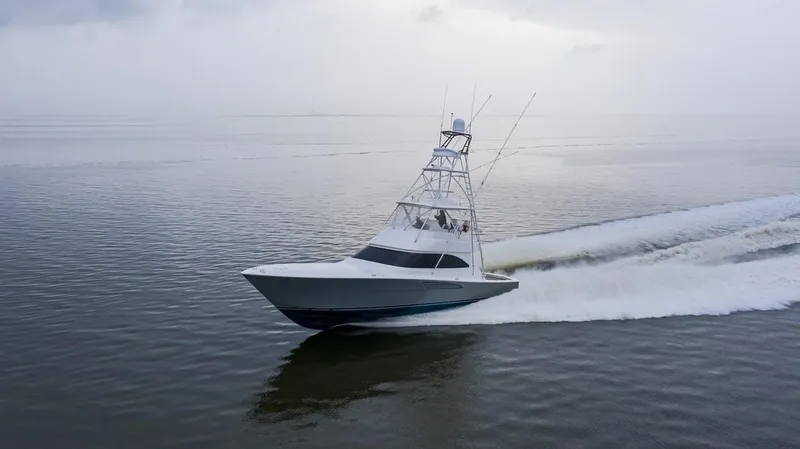 Slide: The Image of 2026 Viking 54 Convertible yacht cruising on calm waters. - 19