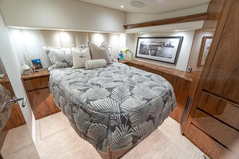 Slide: The Image of Luxurious bedroom interior of 2026 Viking 54 Convertible yacht with elegant bedding and wood accents. - 9