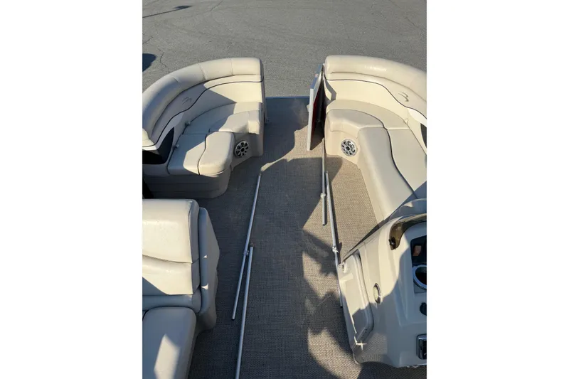 Slide: The Image of 2019 Bennington SX 20 SLX pontoon boat interior with beige seating and carpeted floor. - 4