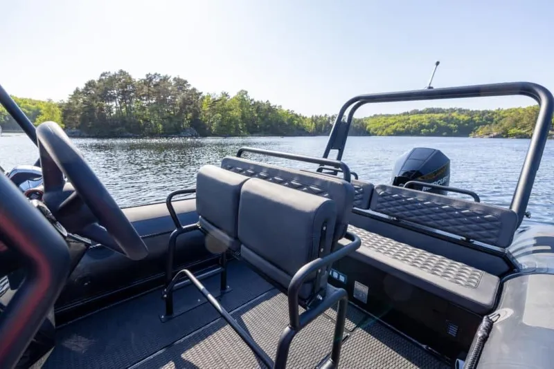 Slide: The Image of Interior view of Highfield Patrol 860 boat, 2026 model, on a serene lake. - 2