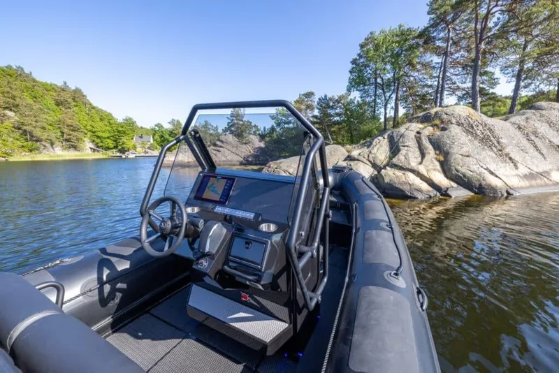 Slide: The Image of Highfield Patrol 860 boat 2026 on calm lake with rocks. - 5