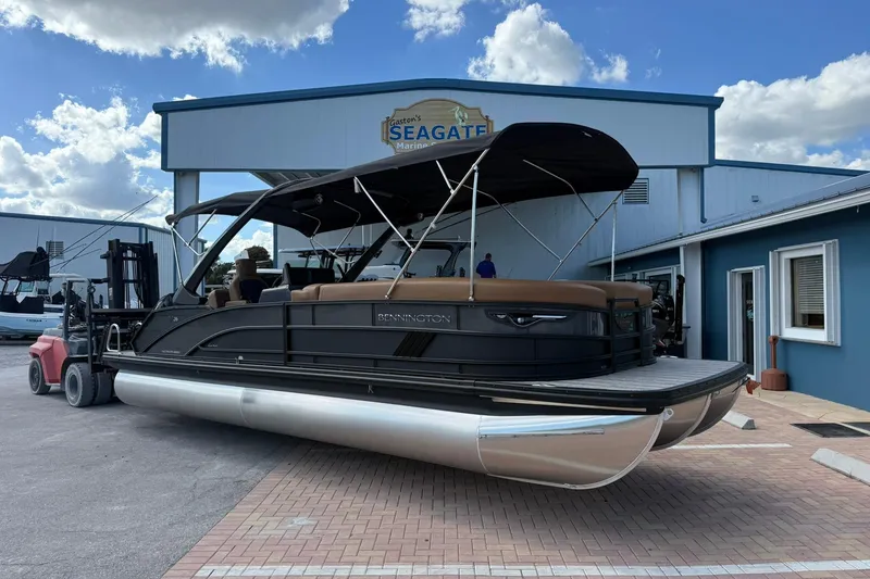 The Image of 2026 Bennington 26 M Swingback pontoon boat at Seagate Marina under a clear sky. - 1
