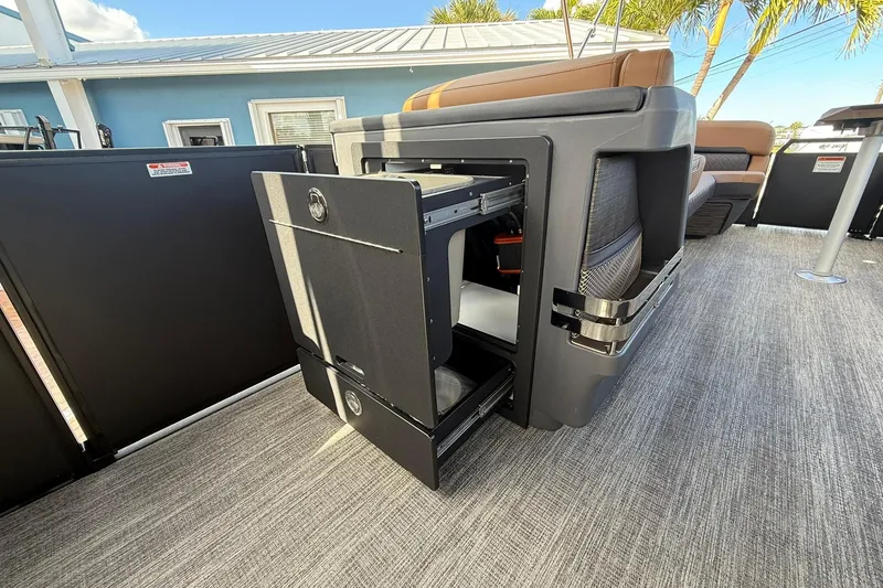 Slide: The Image of 2026 Bennington 26 M Swingback boat with open storage compartment, modern design, and luxurious seating. - 15