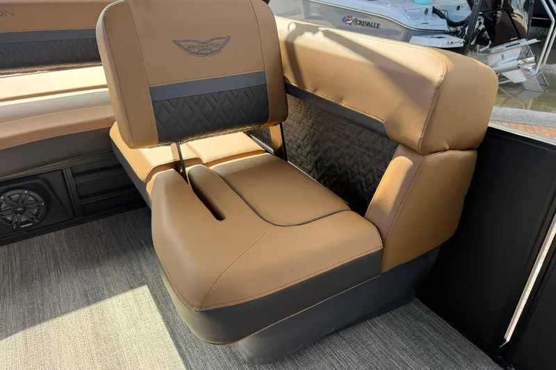 Slide: The Image of 2026 Bennington 26 M Swingback boat seat with tan and black upholstery. - 19