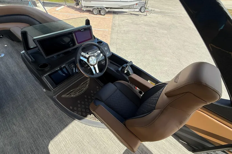 Slide: The Image of Helm of 2026 Bennington 26 M Swingback with luxurious captain's chair and modern dashboard. - 21