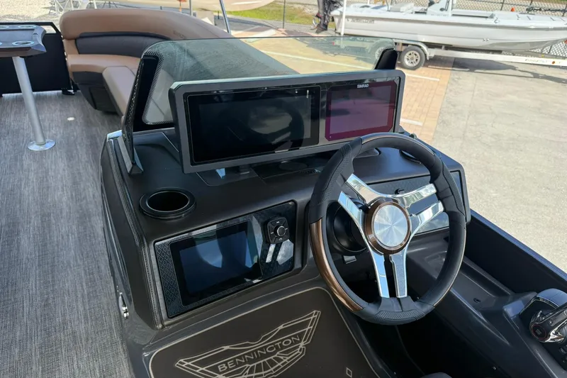 Slide: The Image of 2026 Bennington 26 M Swingback boat dashboard with modern steering and digital displays. - 22