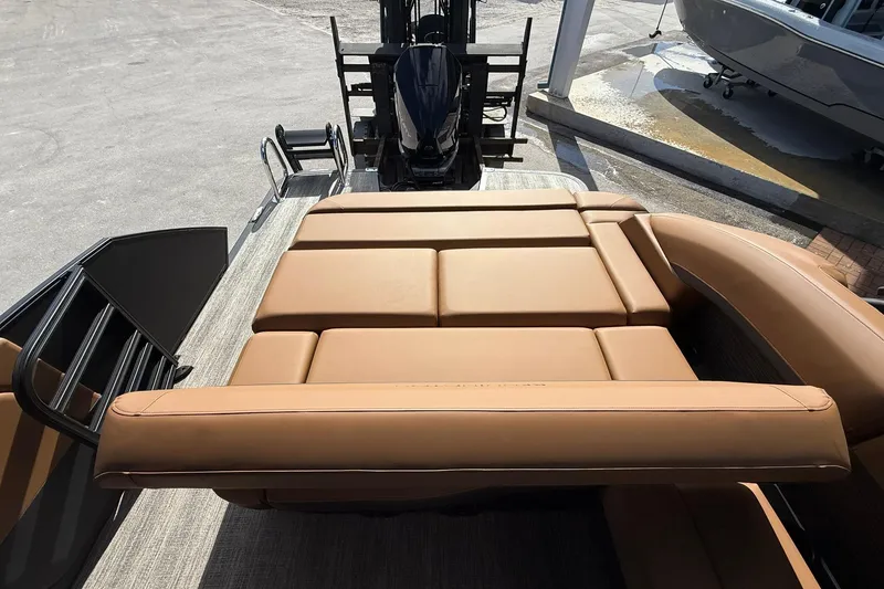 Slide: The Image of 2026 Bennington 26 M Swingback boat with tan leather seating and sleek design. - 23