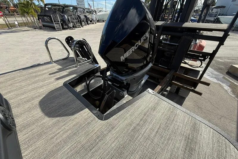 Slide: The Image of 2026 Bennington 26 M Swingback with Mercury outboard motor on display. - 25