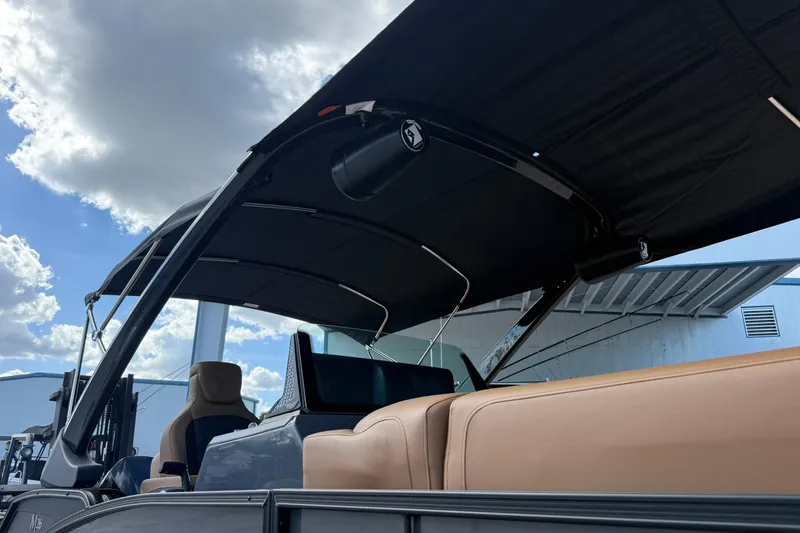 Slide: The Image of 2026 Bennington 26 M Swingback boat with canopy under a cloudy sky. - 3