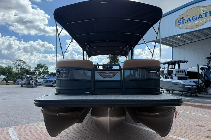 Slide: The Image of 2026 Bennington 26 M Swingback pontoon boat at a marina under a cloudy sky. - 4