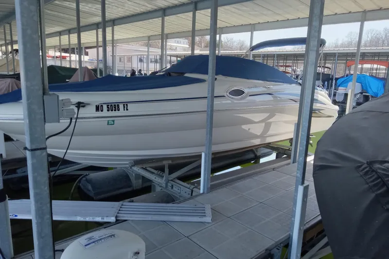 The Image of 2001 Sea Ray 240 Sundeck boat docked in covered marina. - 0