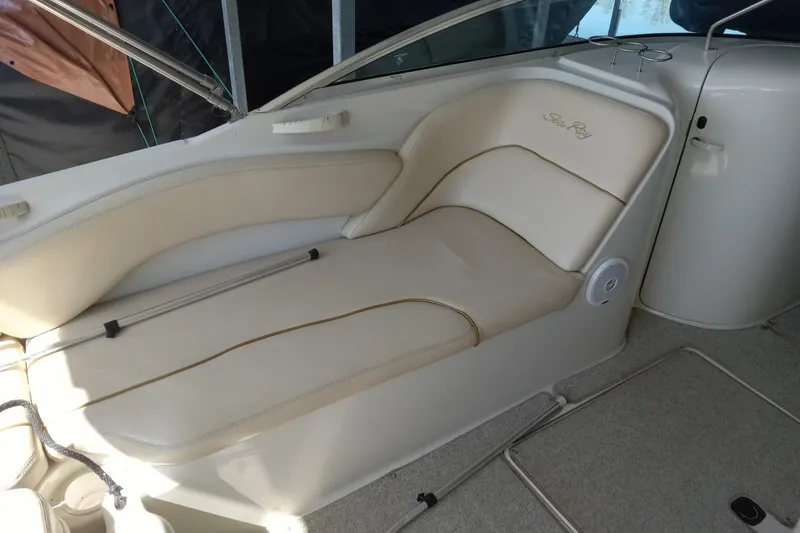 Slide: The Image of 2001 Sea Ray 240 Sundeck interior with beige seating and speaker detail. - 11