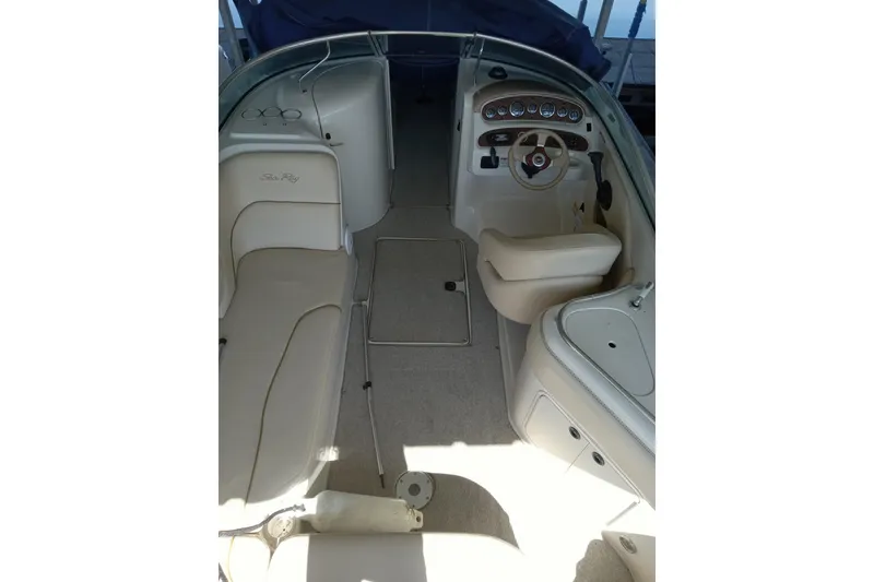 Slide: The Image of 2001 Sea Ray 240 Sundeck interior with beige seating and helm controls. - 4