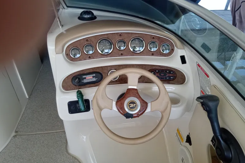 Slide: The Image of 2001 Sea Ray 240 Sundeck dashboard with steering wheel and instrument panel. - 5